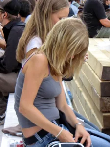 Two girls showing some of their panties while sitting