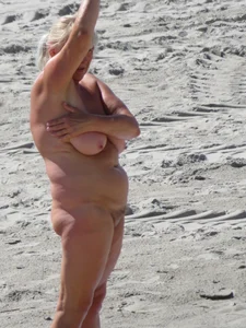 Mature blonde lady on a nude beach with big boobs