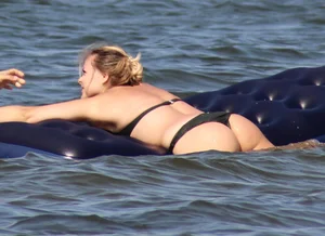 Black thong bikini blonde with a nice ass out on a tube in the water