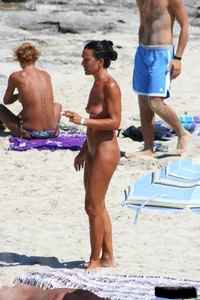 Smoking milf at a nude beach with a hairy pussy