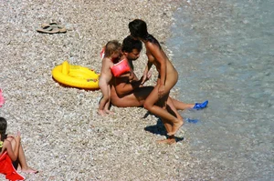 Ula FKK Sexy brunette on a nude beach topless, bottomless and with blue thong
