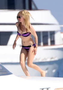 Avril Lavinge looking sexy in purple bikini on a boat