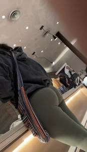 Sexy bubble butt in tight green leggings at the mall