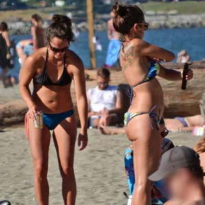 Lady in blue and black bikini at the beach with a nice body