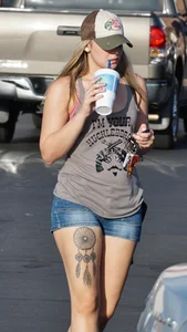 Hot blonde after shopping in short jean shorts and tank top