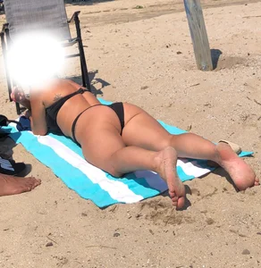 Sunbathers all oiled up and spread
