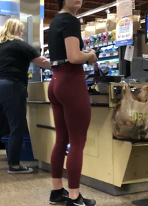Girl with a nice ass in maroon leggings shopping
