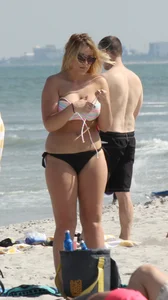 Big boobed thick blonde on the beach in a bikini