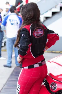 Beautiful and sexy Toyota car girl in red leggings