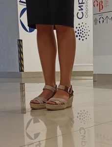 Legs And Feet in Platform Sandals Closeup at an Expo