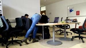 Co-worker bent over table during meeting break