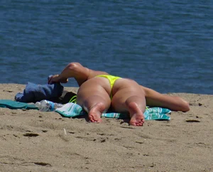 Sexy ass blonde milf on the beach in a thong with cameltoe and bending over