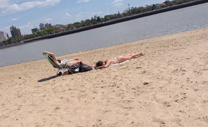 Girl laying out getting sun in a white thong bikini