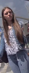Another girl in tight jeans waiting for the bus