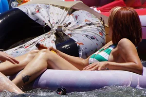 Sexy party girls in bikinis on a lake