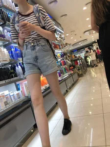 Girl in Blue Denim Shorts with Very Skinny Legs Store Candid