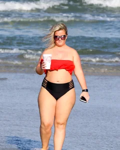 Thick BBW blonde lady in a bikini at the beach