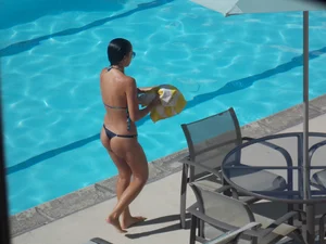 Hot milf sunbathing in a thong by pool and swimming