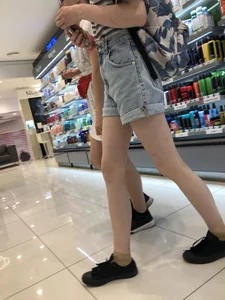 Girl in Blue Denim Shorts with Very Skinny Legs Store Candid