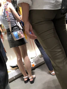 Skinny Girl with Long Legs in Sandals and Denim Skirt Store Candid Photos