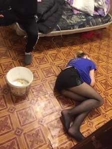 Candid Girl in a Skirt and Black Pantyhose Lying on the Floor Curled Up