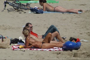 Girls on a nude beach in Sitges, Spain