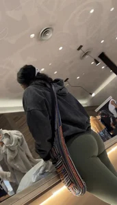 Sexy bubble butt in tight green leggings at the mall