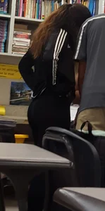College girl revealing tiny thong while bending over in classroom