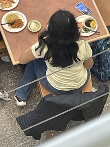 Chubby girl in tight jeans eating dinner