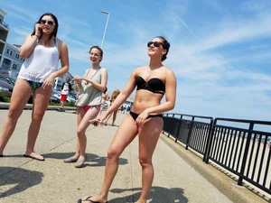 Cute brunette looking sexy in black bikini with friends