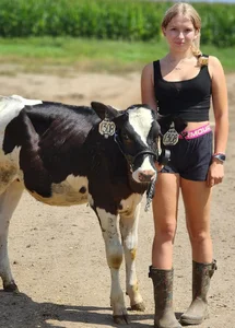 Very cute non-candid blonde teen with a cow