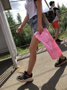 Cute Girl in Denim Shorts Walking Down a Railway Station Gallery