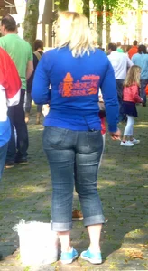 Blonde stocky girl in blue jeans in the park