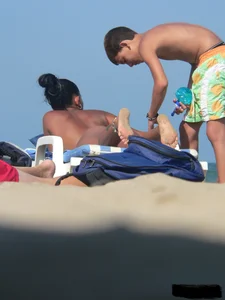 Hot ass topless beach girl with great tits lets her little brother oil up her ass in thong bikini