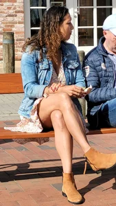 Canid milf in a dress with nice crossed legs sitting on a bench