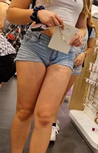 A Cute Young Girl in a Top And Denim Mini Shorts at the Shop Photos