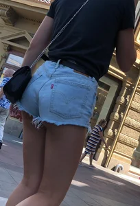 Shorts girl walking with nice legs and some cheeks showing
