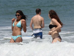 Brunette and redhead on the beach in bikinis looking sexy