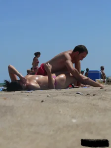 Purple thong topless lady on the beach gets oiled up by her husband
