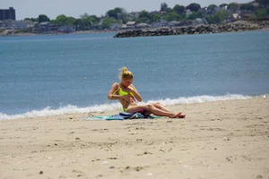 Sexy ass blonde milf on the beach in a thong with cameltoe and bending over