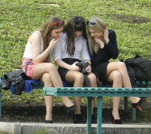 Group of Hot Girls in Blouses, Skirts and High-Heeled Shoes Photographing Each Other In a Park Creepshots