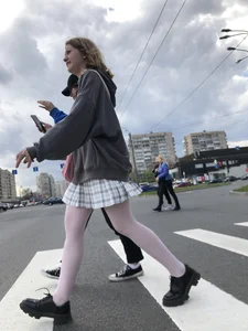 Candid teen girl wearing a skirt and white pantyhose crossing the street creepshots
