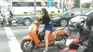 Girl in a Skirt on a Scooter