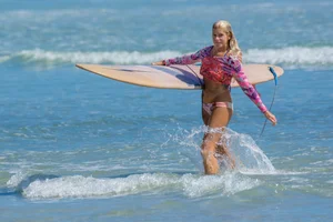 Candid girls surfing on the beach