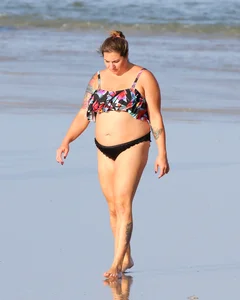 Thick flat assed tattooed lady on the beach in a bikini