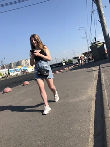 A very cute street candid girl wearing a denim fringed skirt passing by, great legs