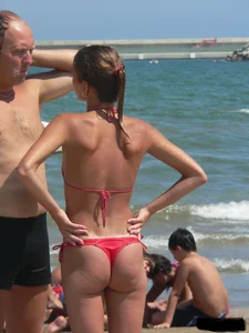 A bunch of hot babes on the beach in thong bikinis