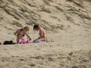 Topless beach girl with nice titties with her friend in a bikini