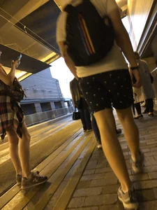 Cute Teen in Shorts on the Tram Stop