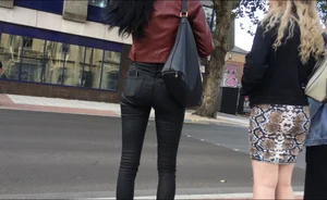 Chav brunette with a nice ass and vpl in tight black leather pants